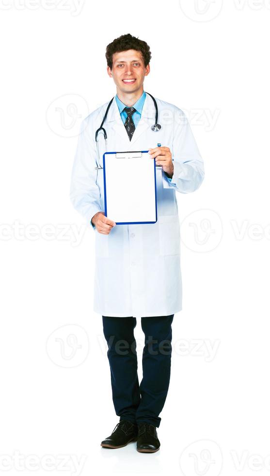 Young smiling male doctor showing clipboard with copy space for text on white photo