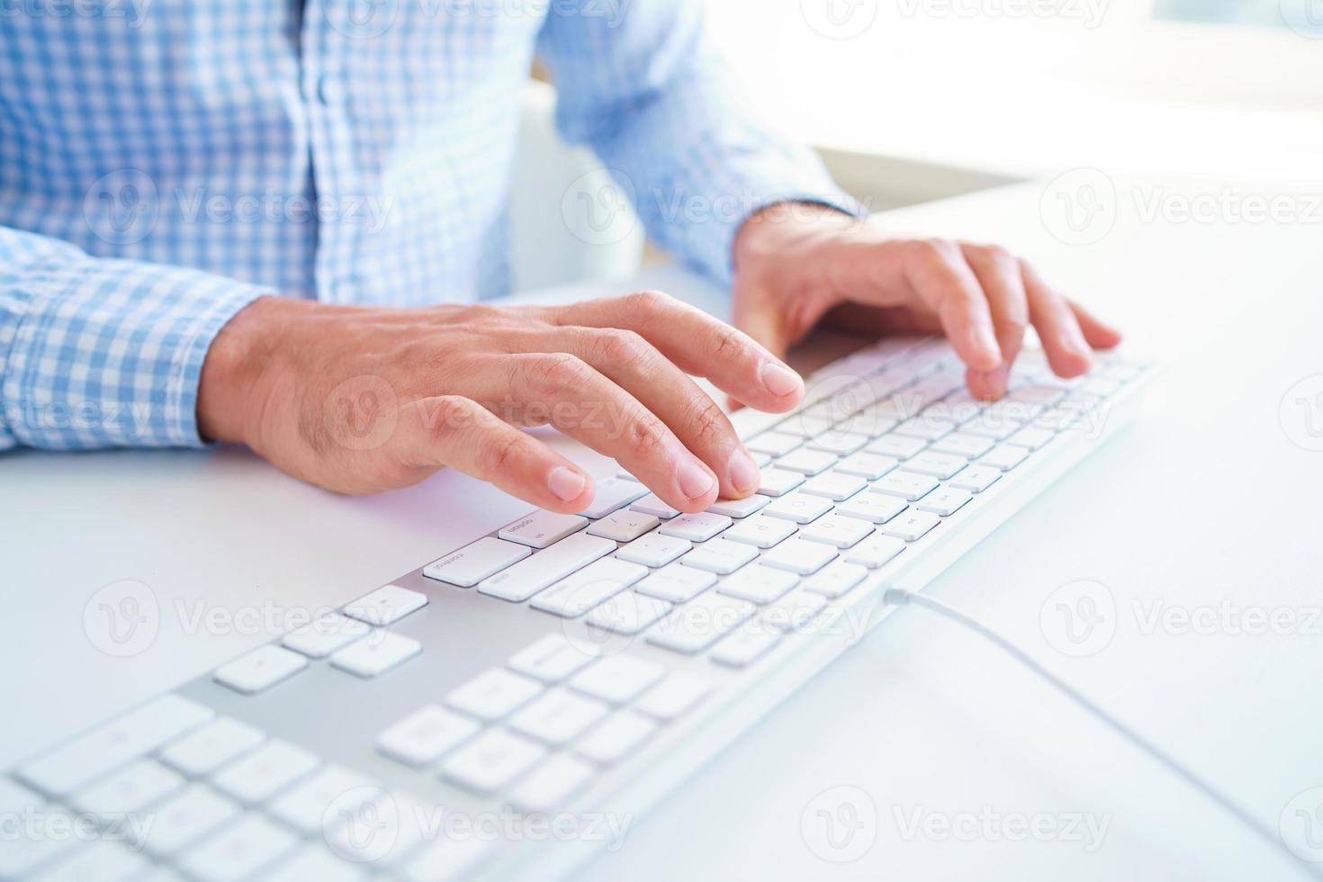 Men office worker typing on the keyboard photo