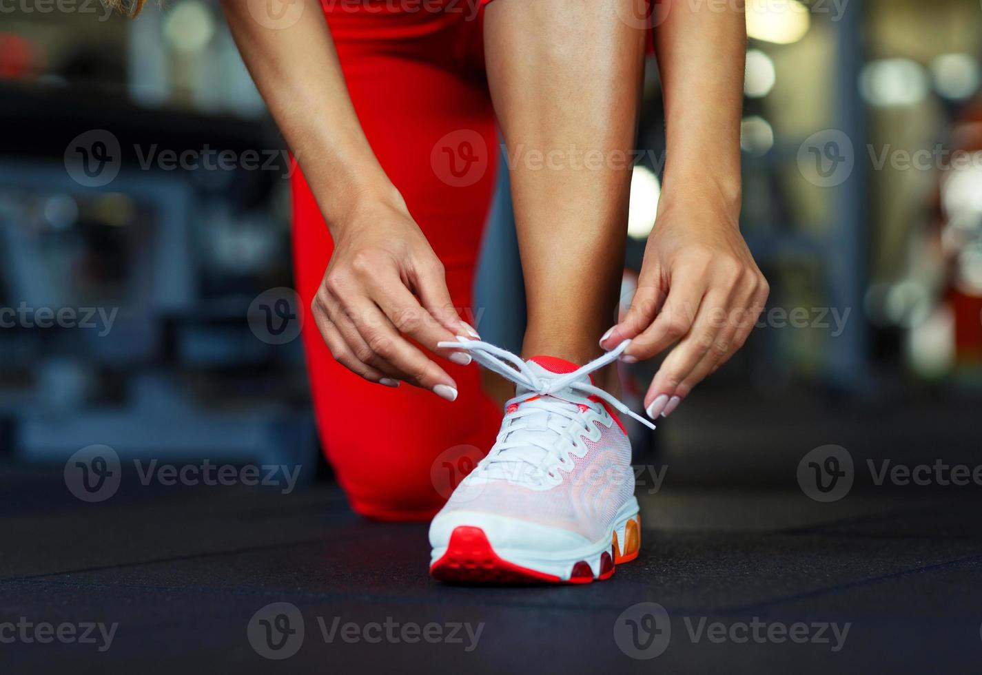 Running shoes - woman tying shoe laces photo