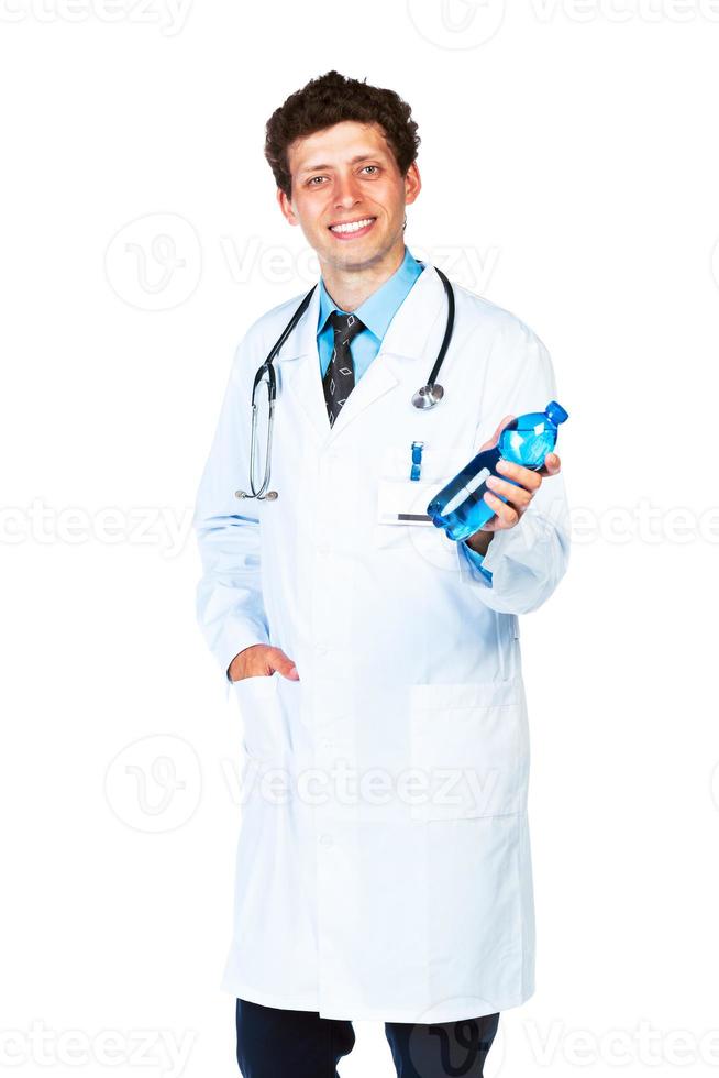 Portrait of a smiling male doctor holding bottle of water on white photo