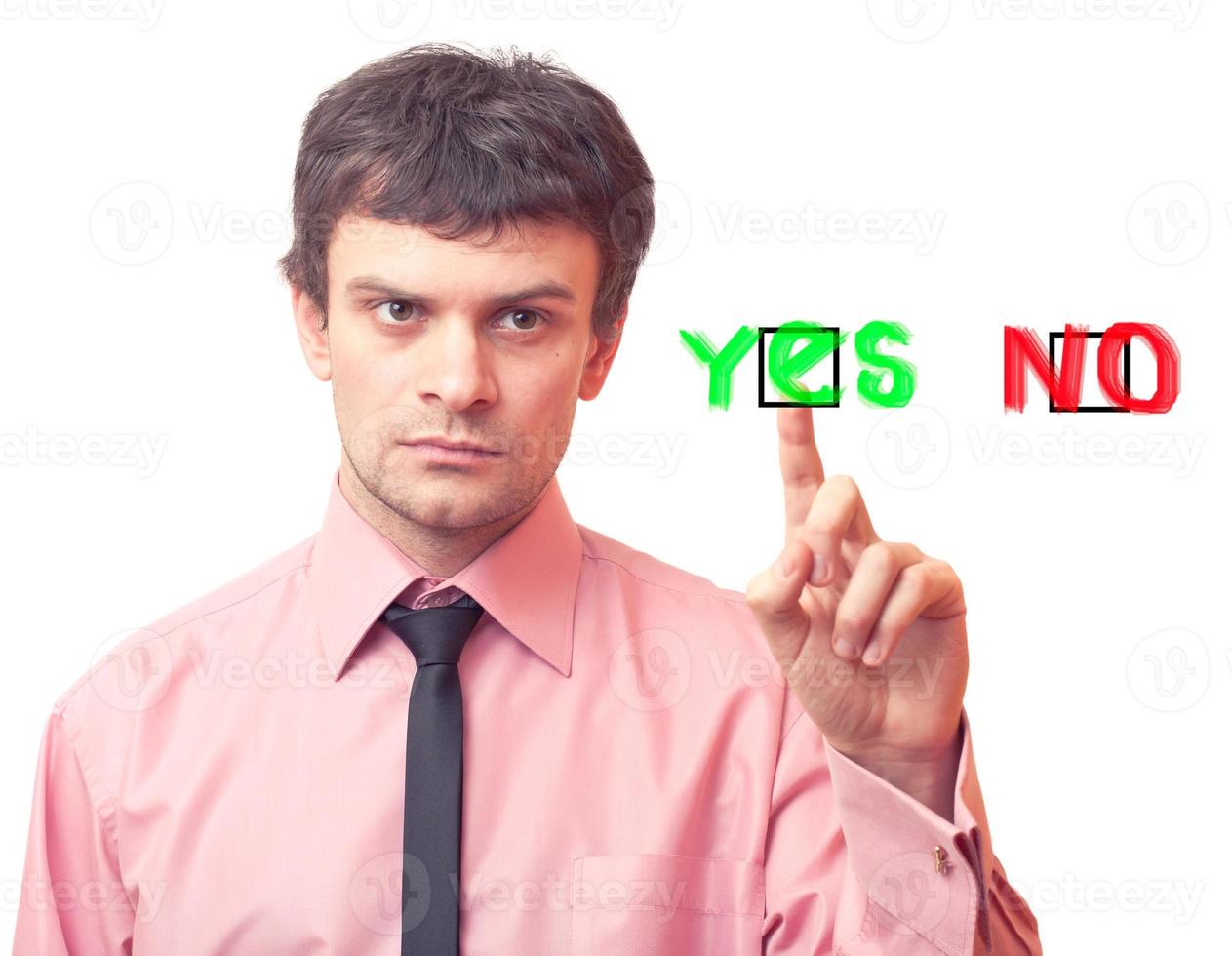 Business man presses button YES photo