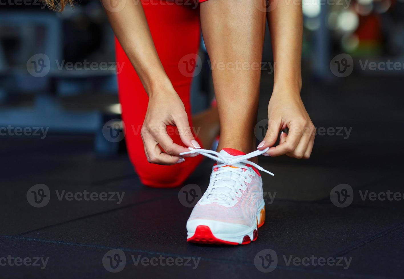 Running shoes - woman tying shoe laces photo
