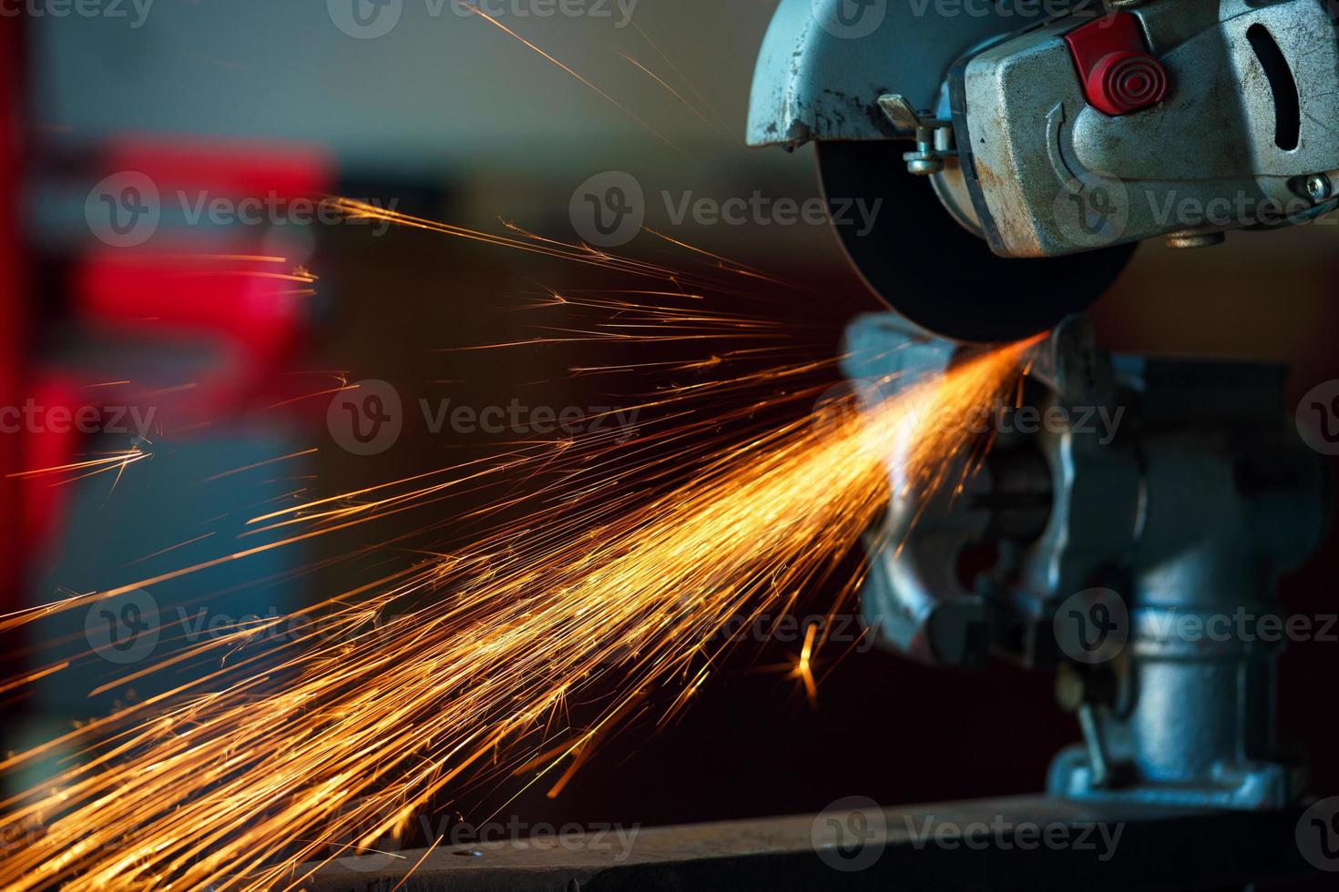 Angular grinding machine is cutting the metal and a lot of sparks photo