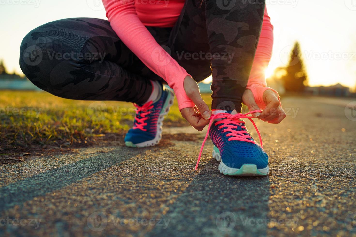 Running shoes - woman tying shoe laces photo