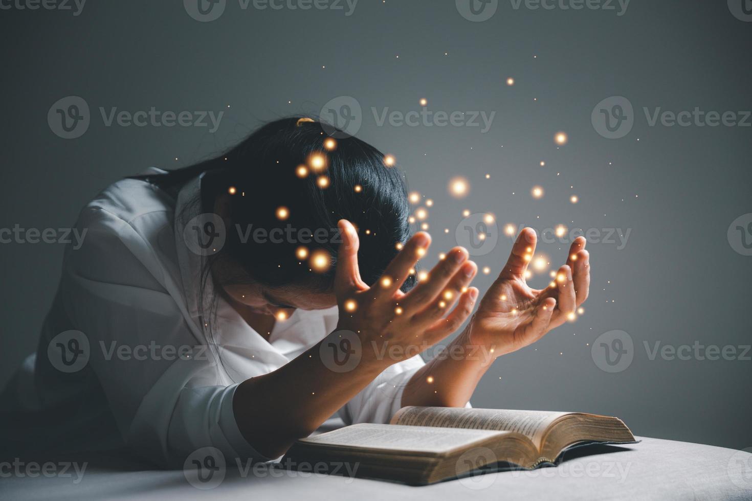 woman kneeling and praying in modern house at sunset time. Female catholic prayer worship to God wish a better life in home at dawn with believe faith. concept of worshipers kneeling. photo