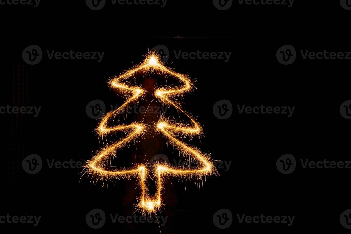 Tree made with sparklers ready for your inscriptions on black background photo