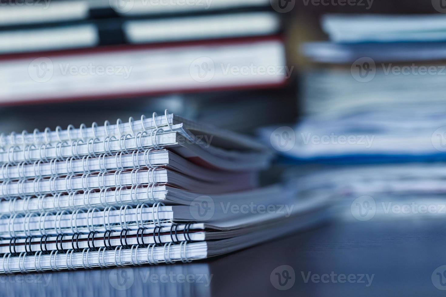 Accounting and taxes. Pile of magazine, notebook and books closeup photo