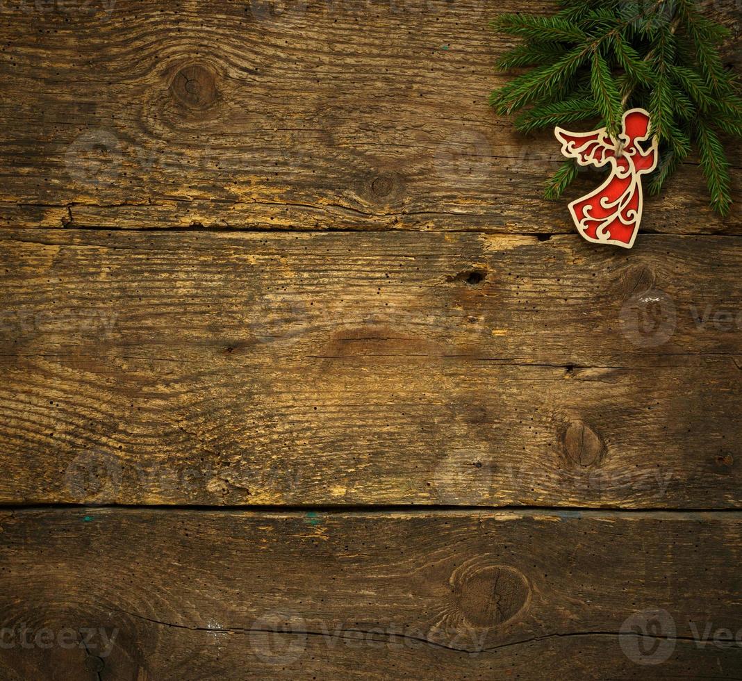 Christmas tree branches with christmas decorations on wooden texture ready for your design photo
