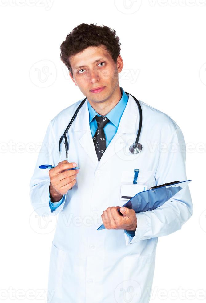 Young male doctor writing on a patient's medical chart photo