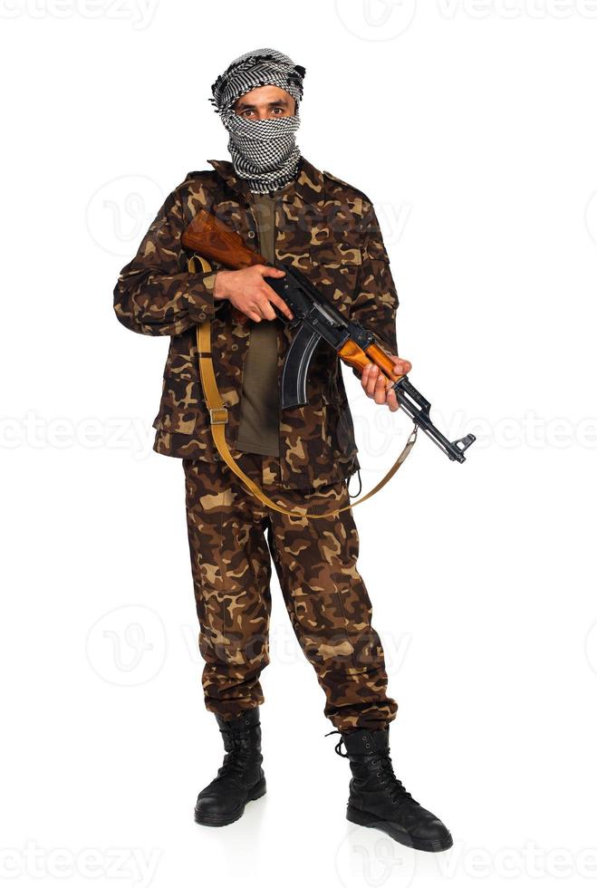 Arab nationality in camouflage suit and keffiyeh with automatic gun on white background photo