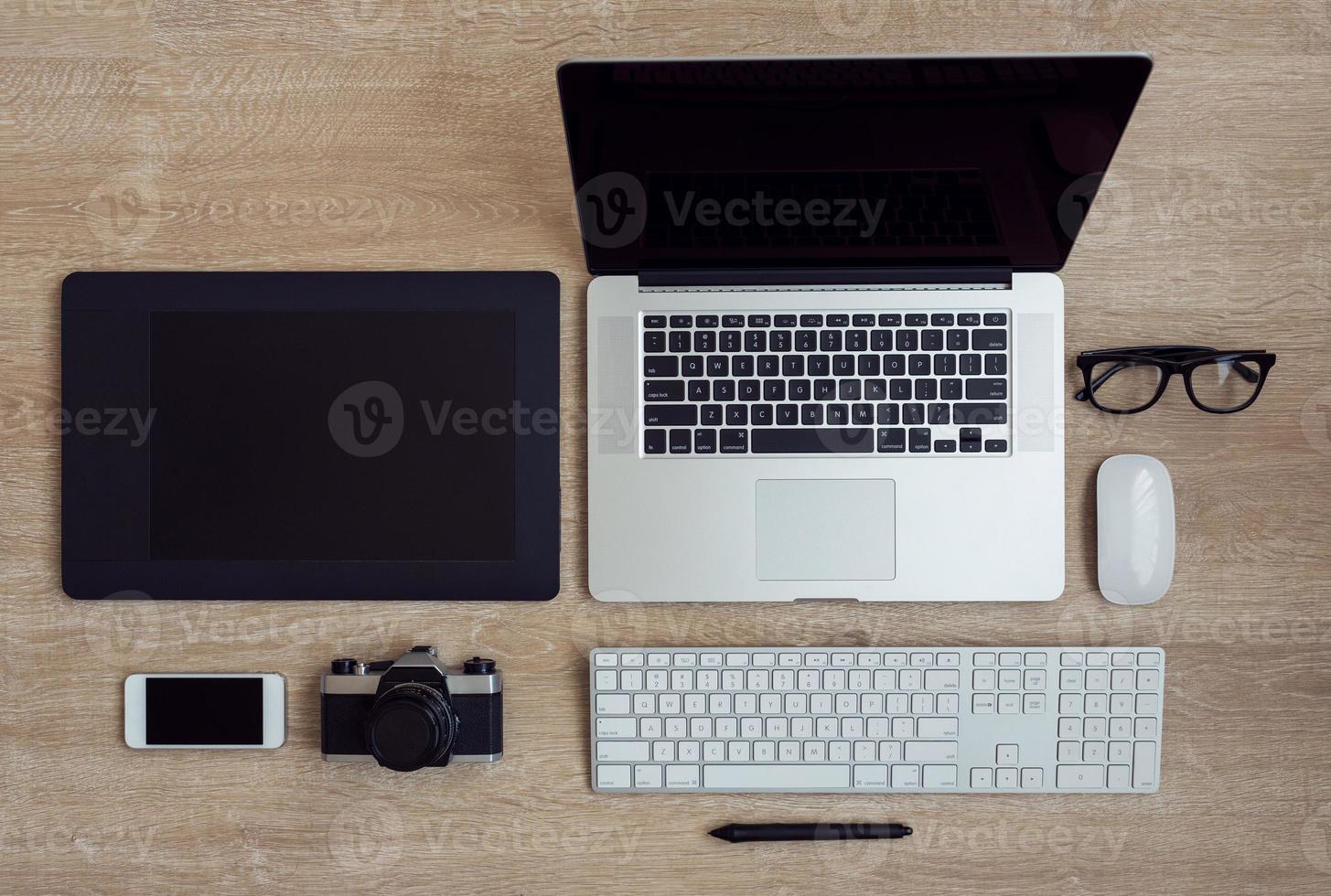 Business workplace with laptop and gadgets on wooden background photo