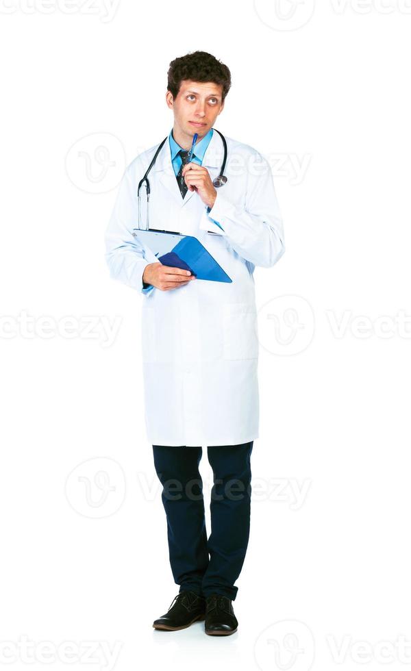 Young male doctor writing on a patient's medical chart photo