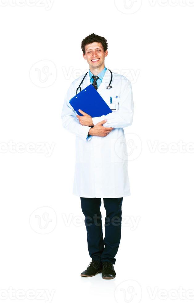 Full length portrait of a smiling male doctor holding a notepad on white photo