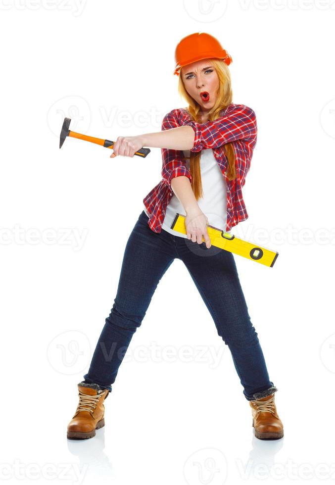 Young woman in helmet with the work tools on a white photo