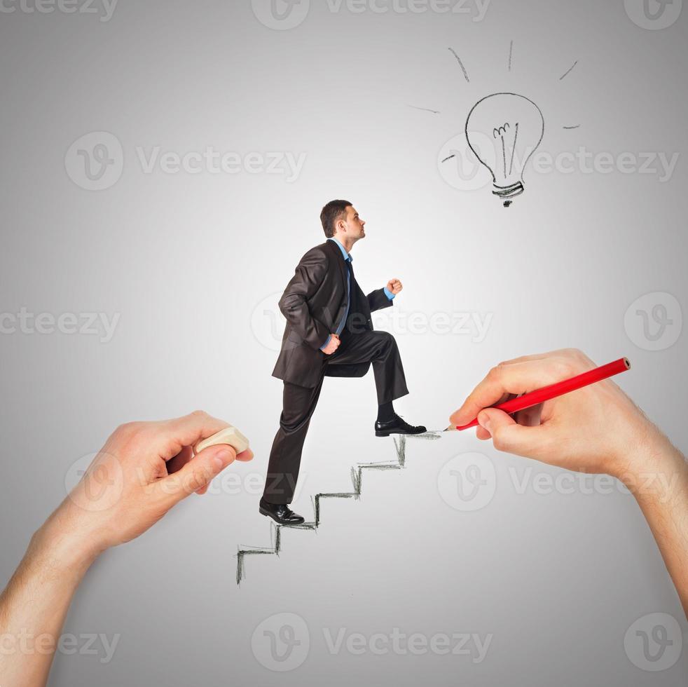 Hand draws stairs with walking businessman photo