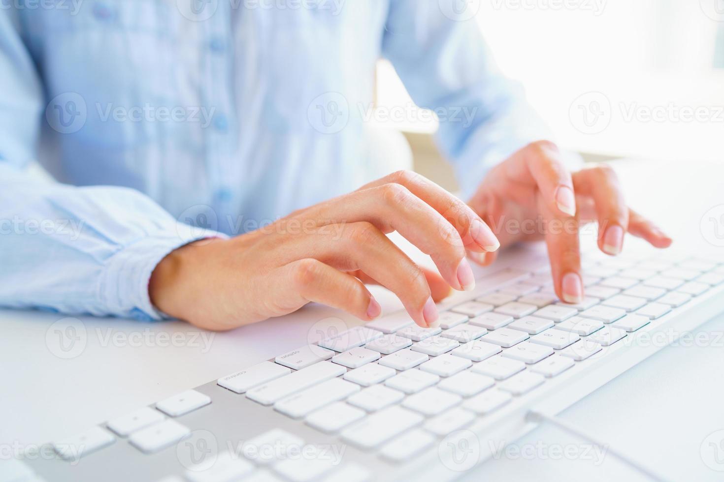 Female woman office worker typing on the keyboard photo