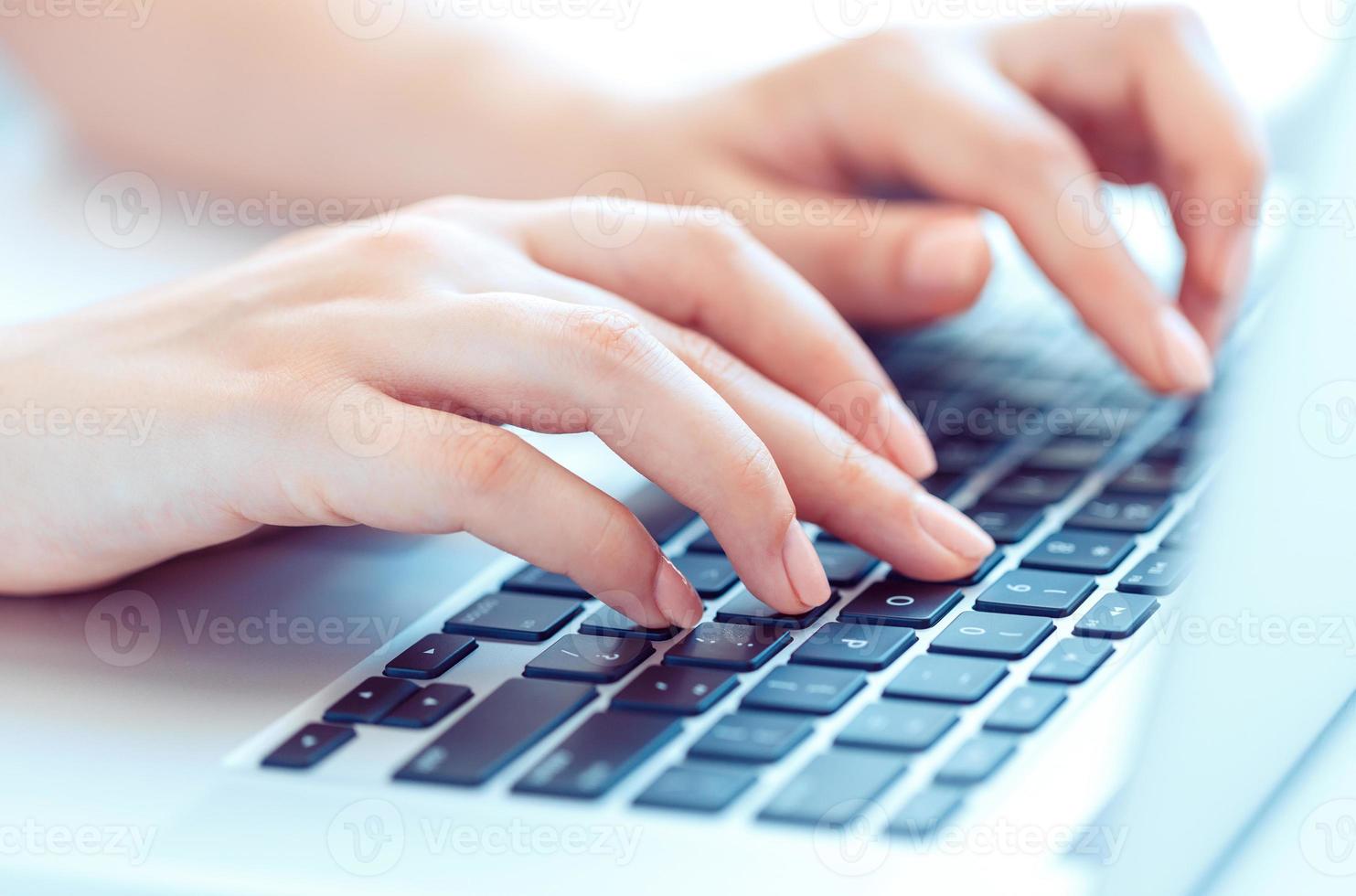 Female hands or woman office worker typing on the keyboard photo