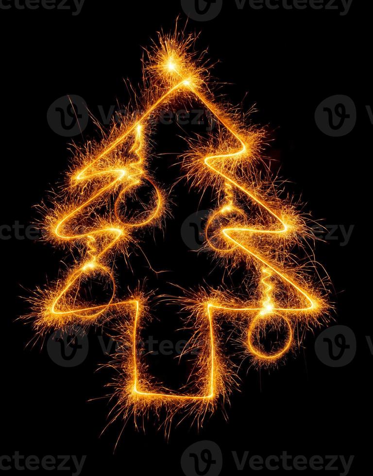 Christmas tree made by sparkler on a black photo