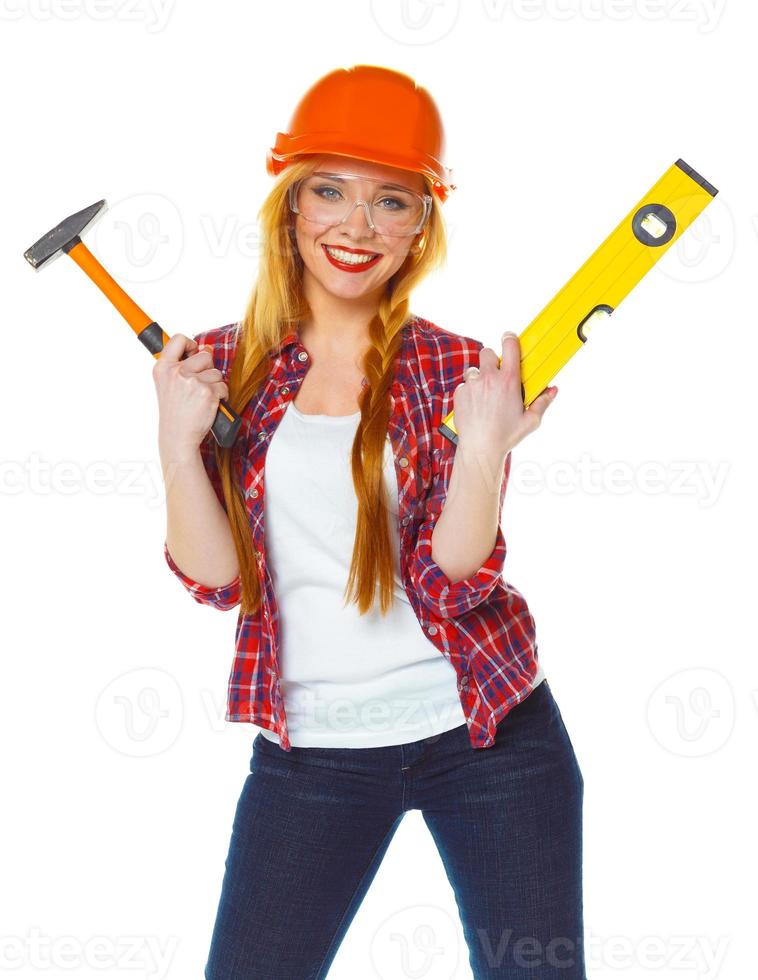 Young woman in helmet with the work tools on a white photo
