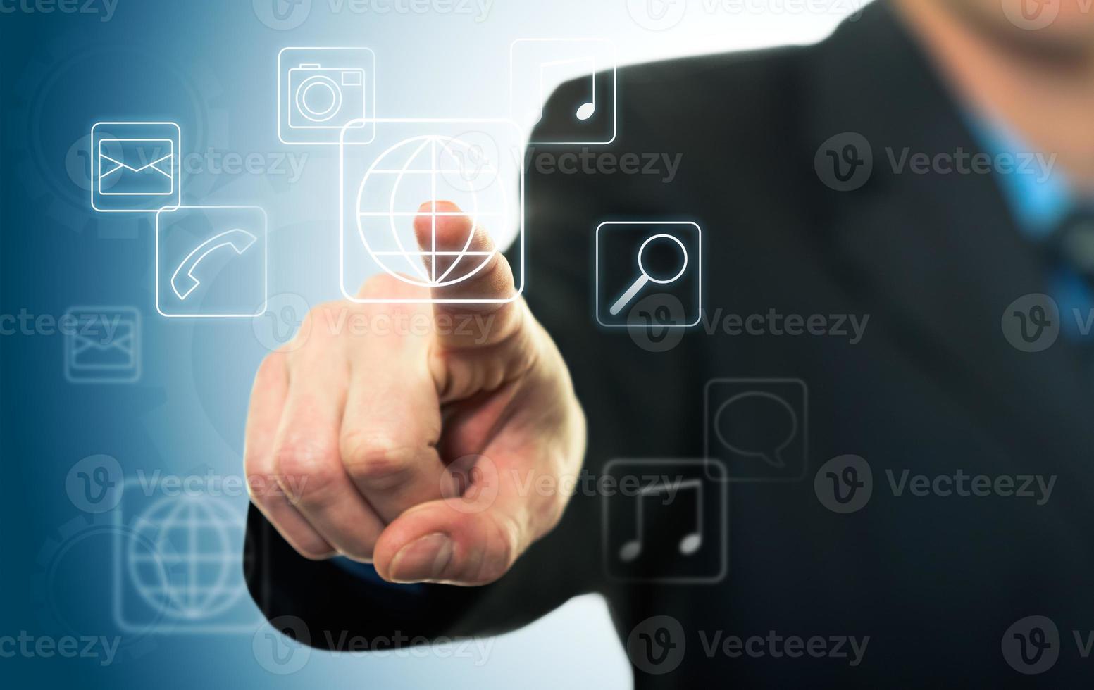 Businessman pressing application button with touch screen photo