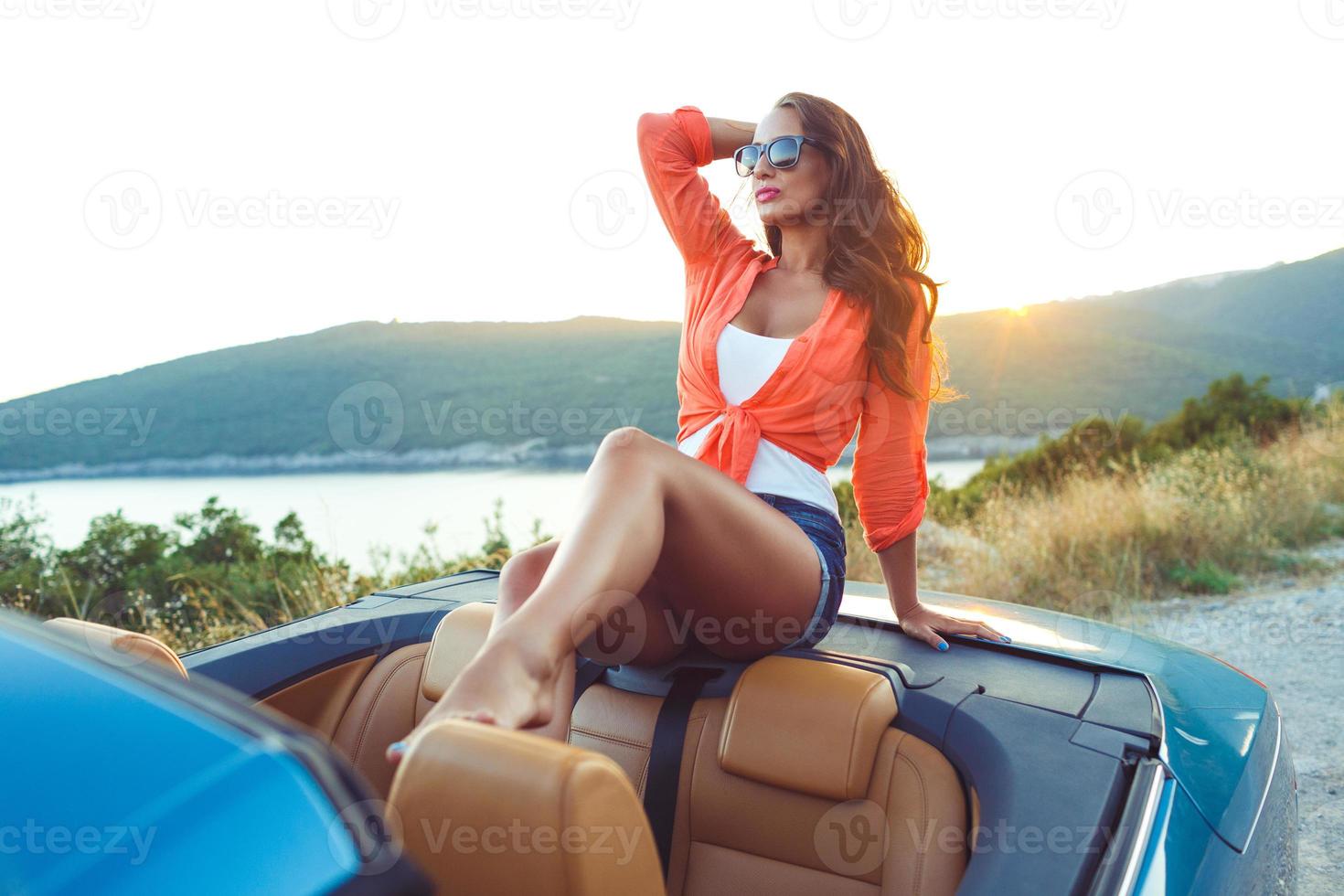 Beautiful woman sitting in cabriolet, fashionable lifestyle concept photo