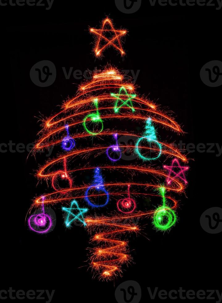 Christmas tree made by sparkler on a black photo