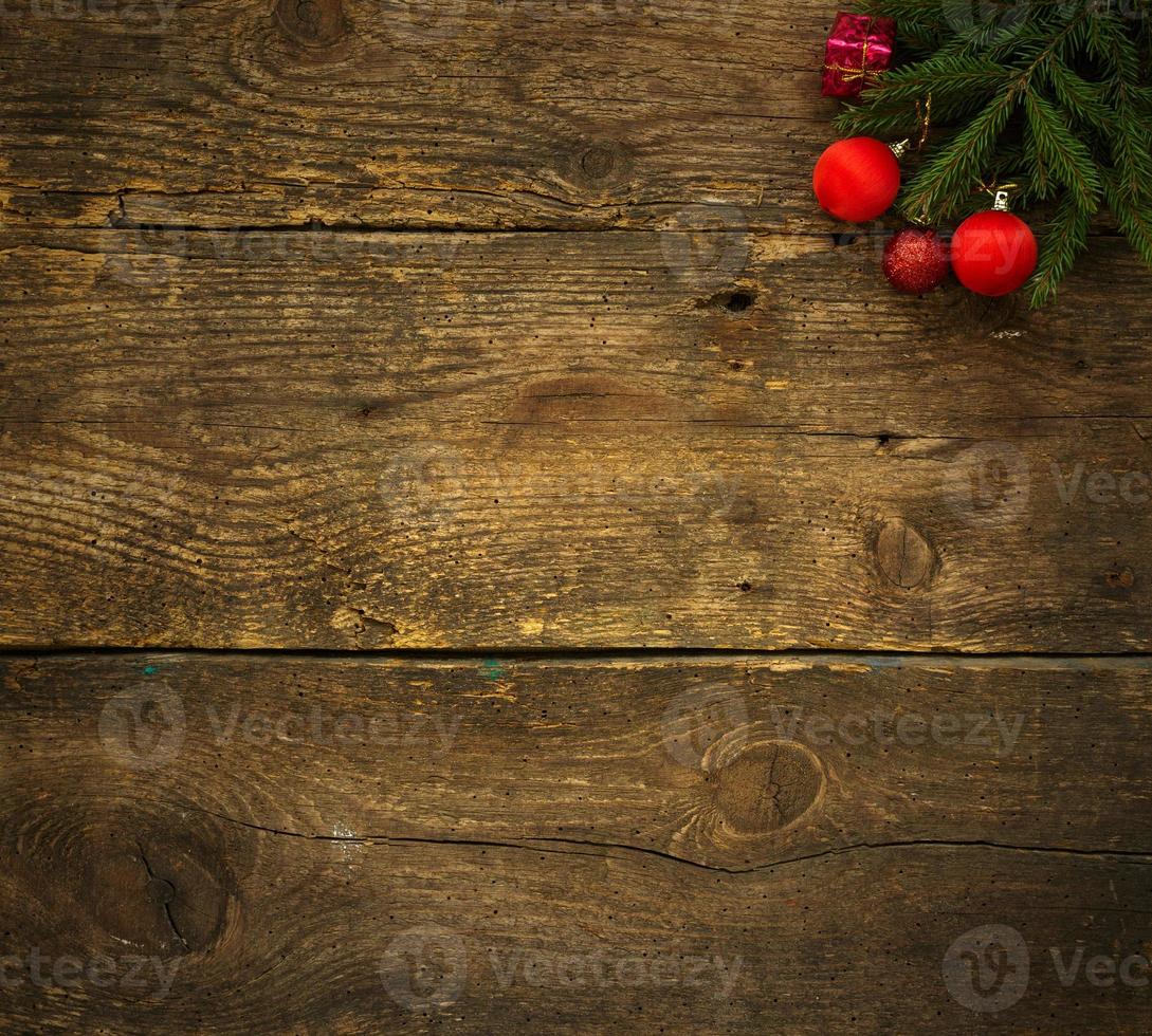 Christmas tree branches with christmas decorations on wooden texture ready for your design photo