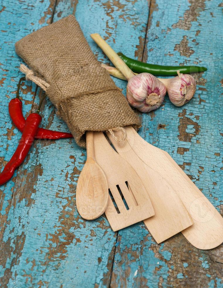 Wooden spoons with vegetables photo