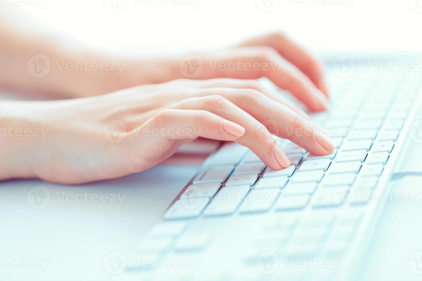 Female hands or woman office worker typing on the keyboard photo