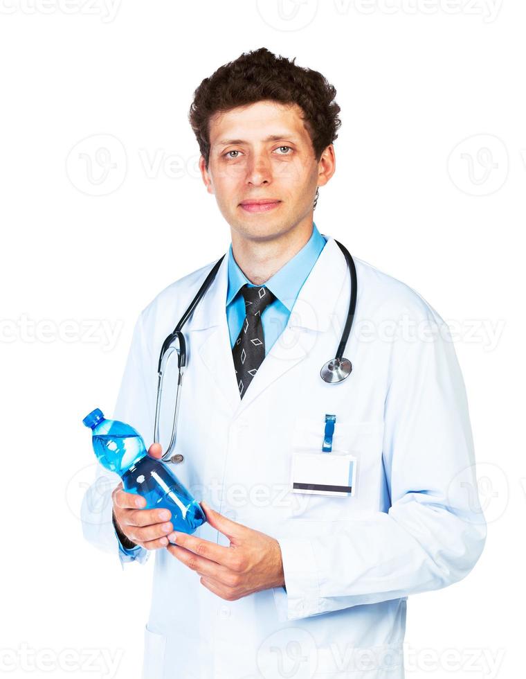 Portrait of a smiling male doctor holding bottle of water on white photo