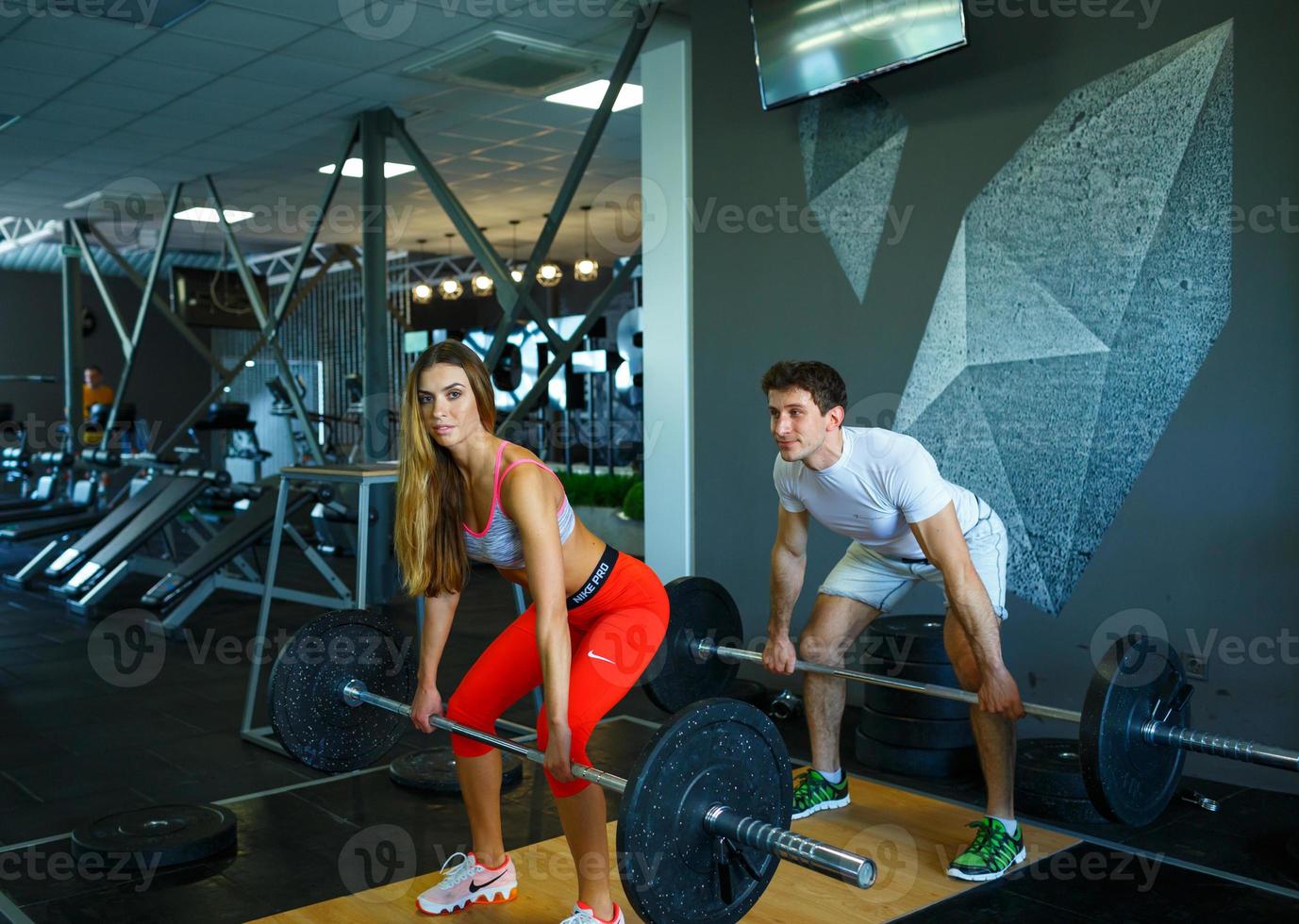 Man and woman working out at the gym photo