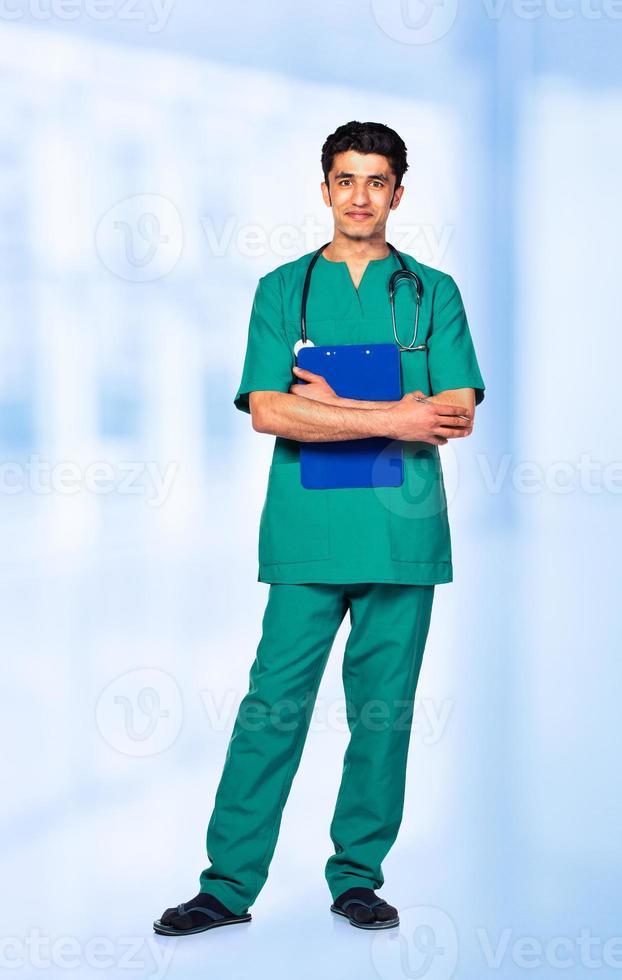 Portrait of the smiling arab doctor on interior photo