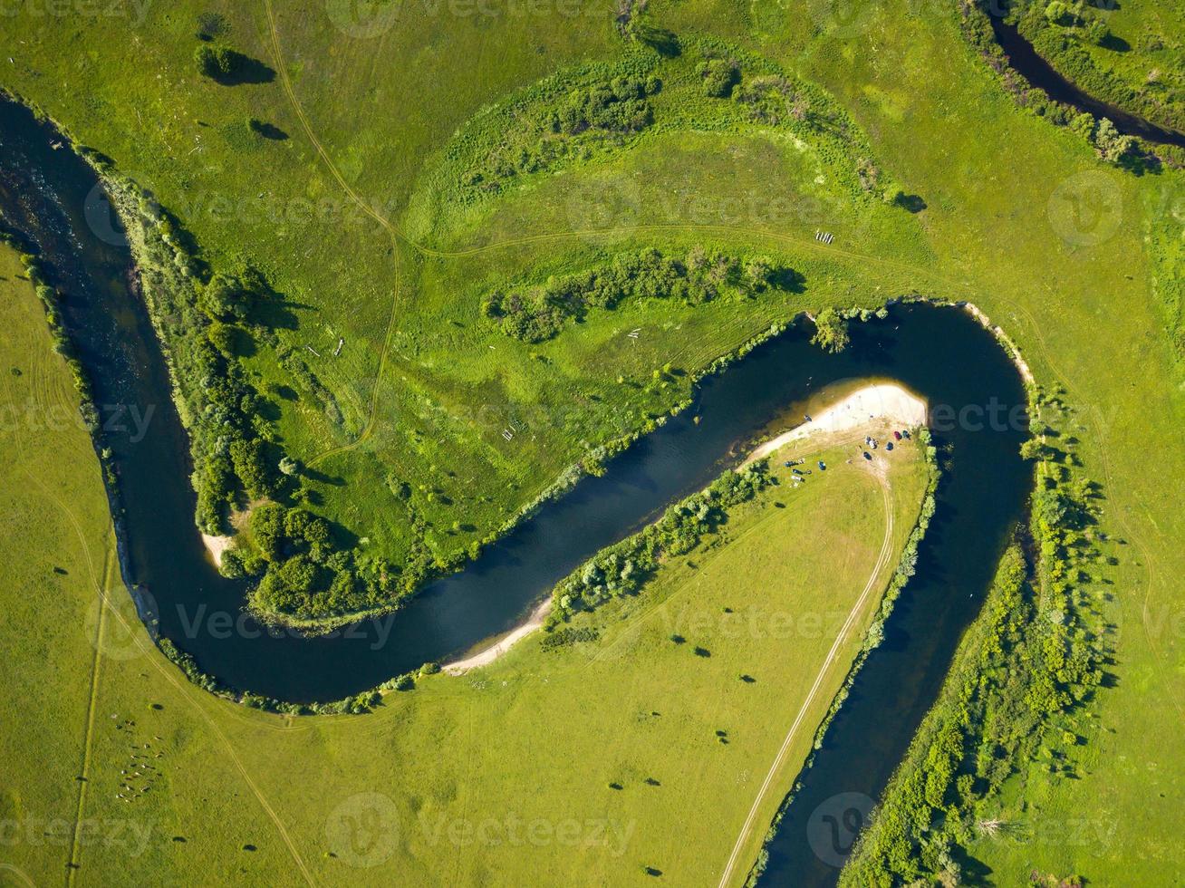 Top view of the Seim River, Ukraine, surrounded by trees and meadows on its banks, view from the top photo