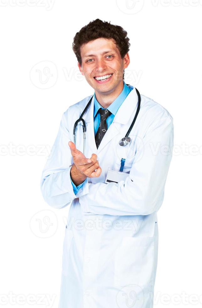 Portrait of a smiling male doctor showing finger at you photo