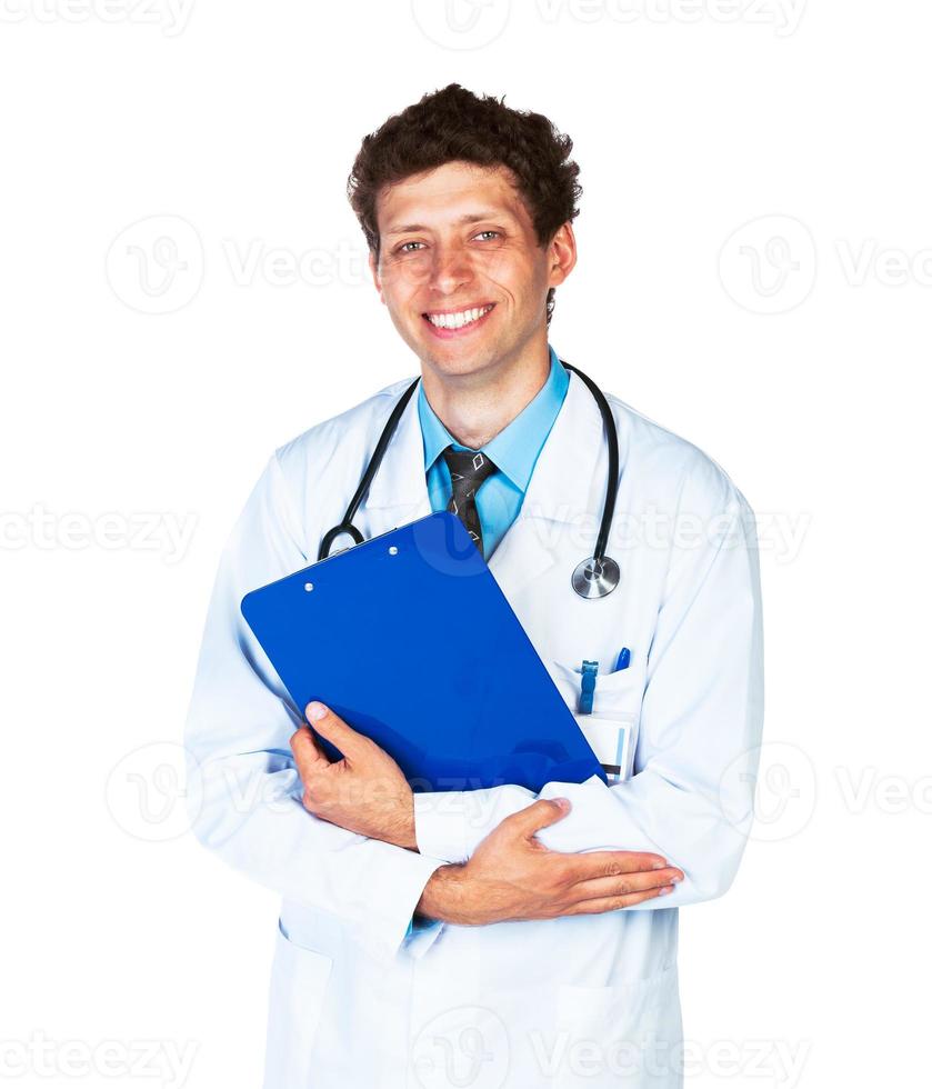 Portrait of smiling young male doctor writing on a patient's medical chart on white photo