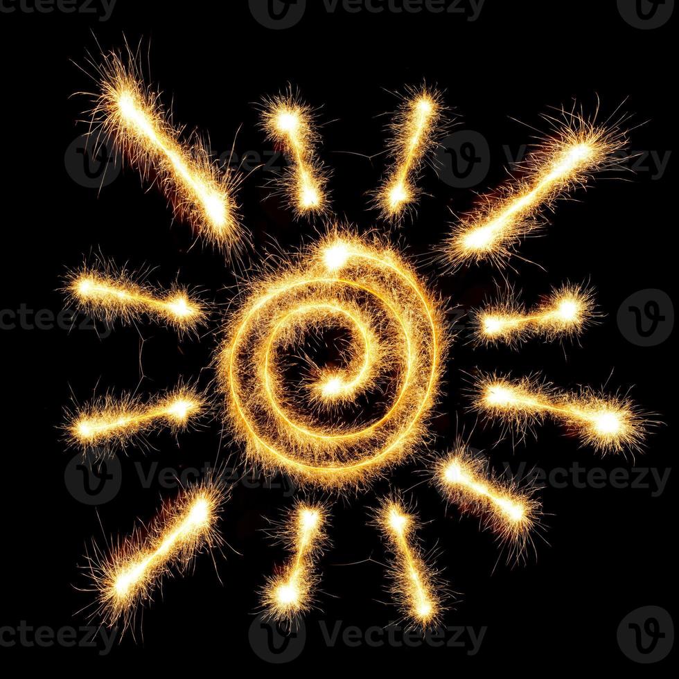 Sun sparkler on dark background photo