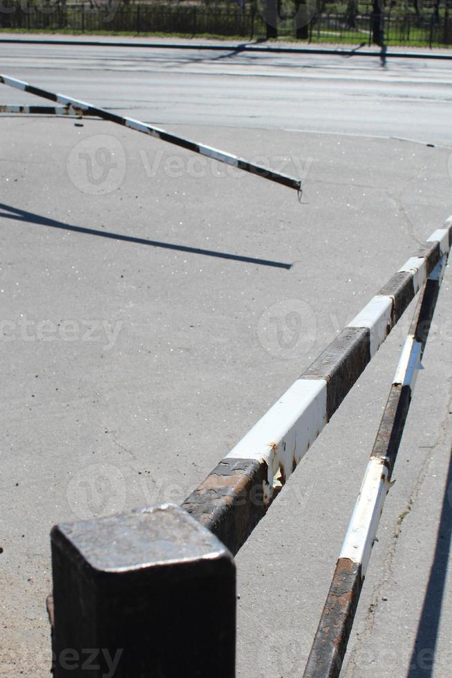 A closeup shot of a black white striped boom barrier photo