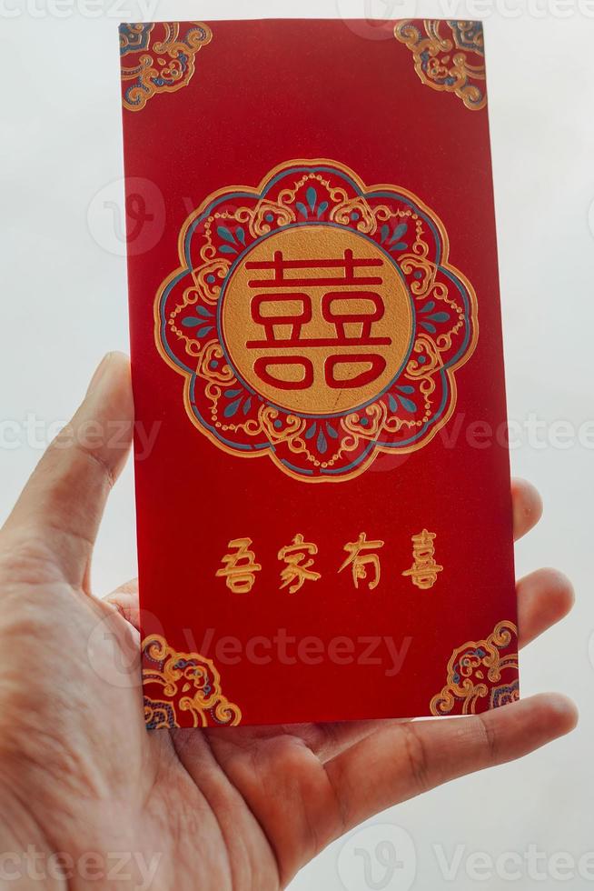 hand holding red envelope gift chinese new year photo