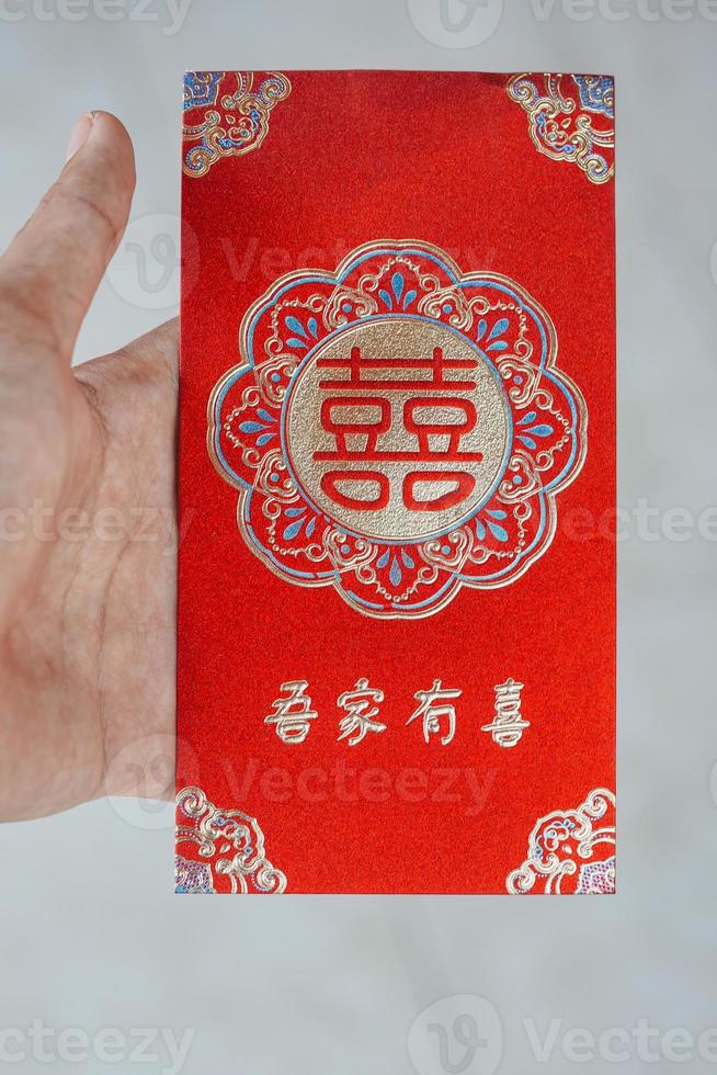 hand holding red envelope gift chinese new year photo