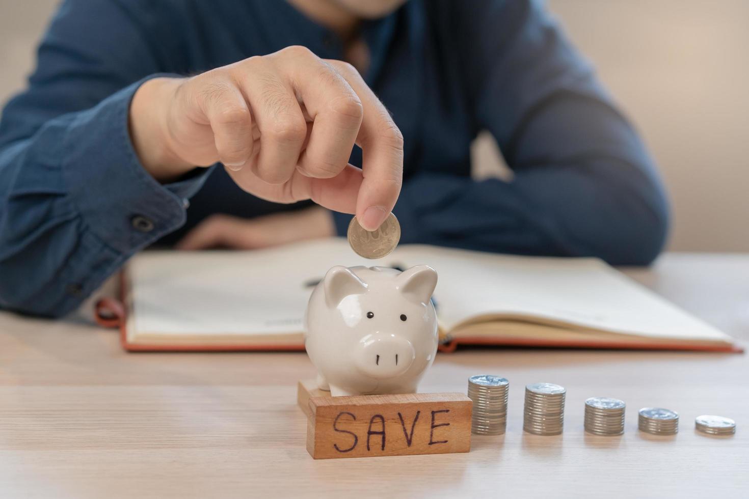 Close up hand of asian young businessman, male is press calculator to calculate cost, financial plans to spend enough money on his income for saving money and payment, payday. Finance people concept. photo