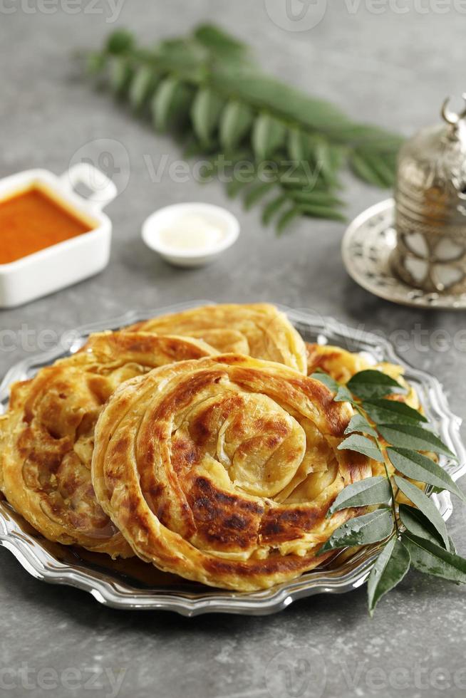 Roti Parata or Roti Canai with Chicken Curry Sauce photo