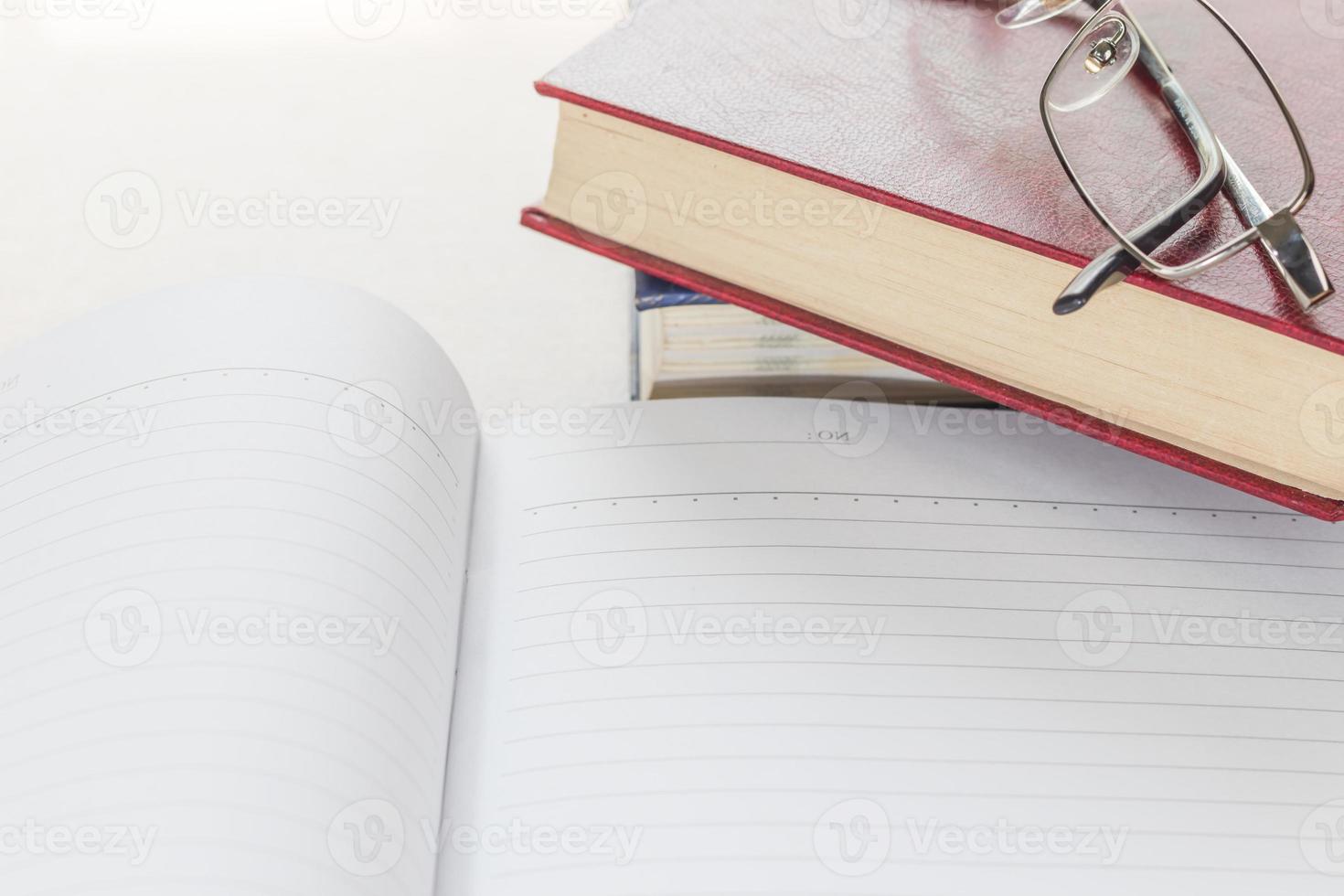 Eyeglasses and Notepad with blank page photo