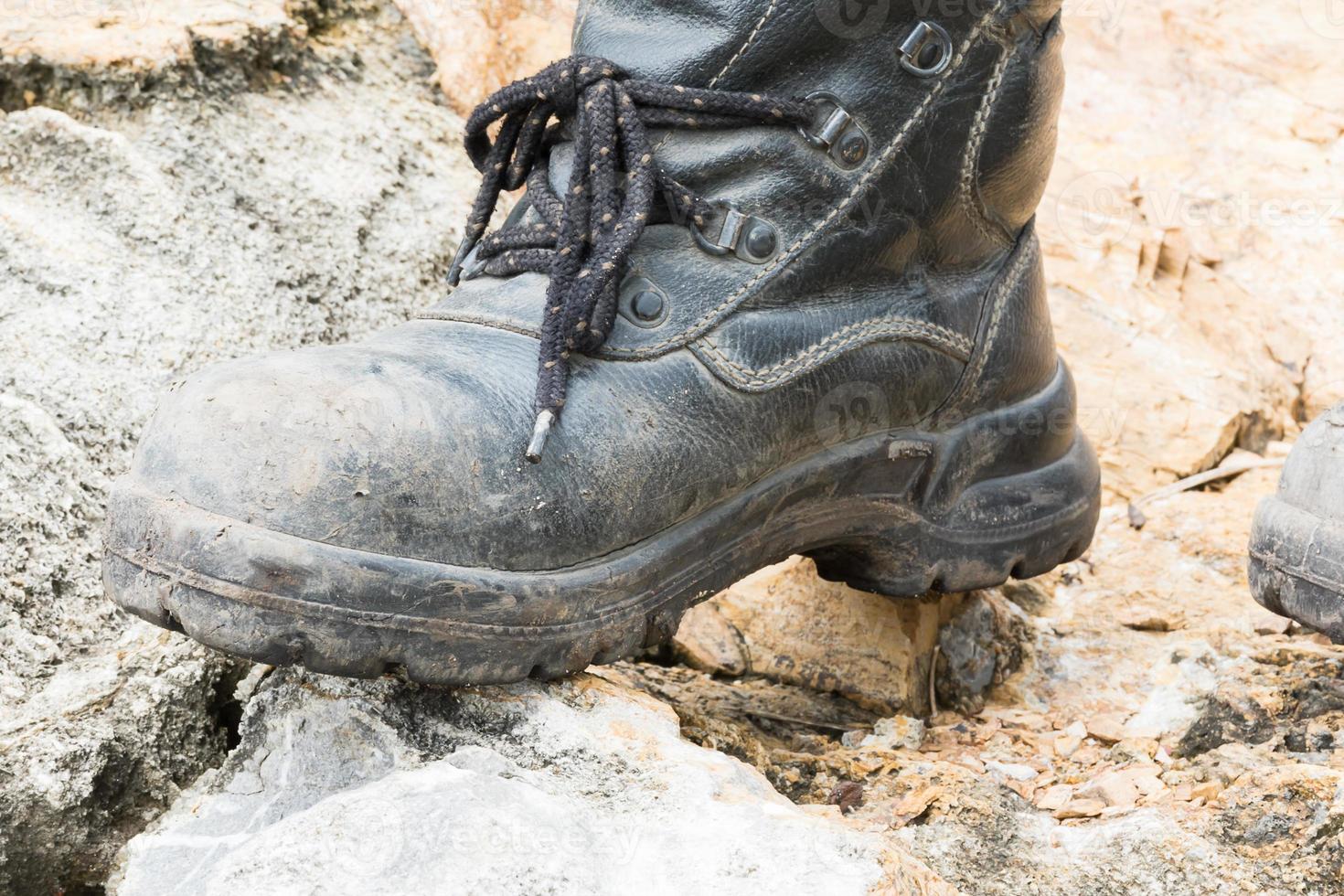 Trekking leather boot on the rock photo