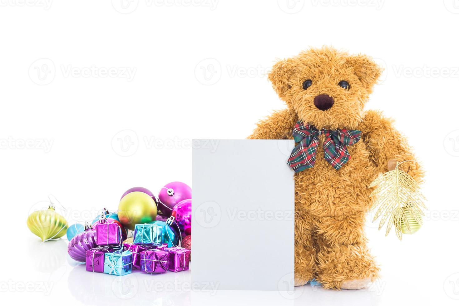 Teddy bear with gifts and blank greeting card photo