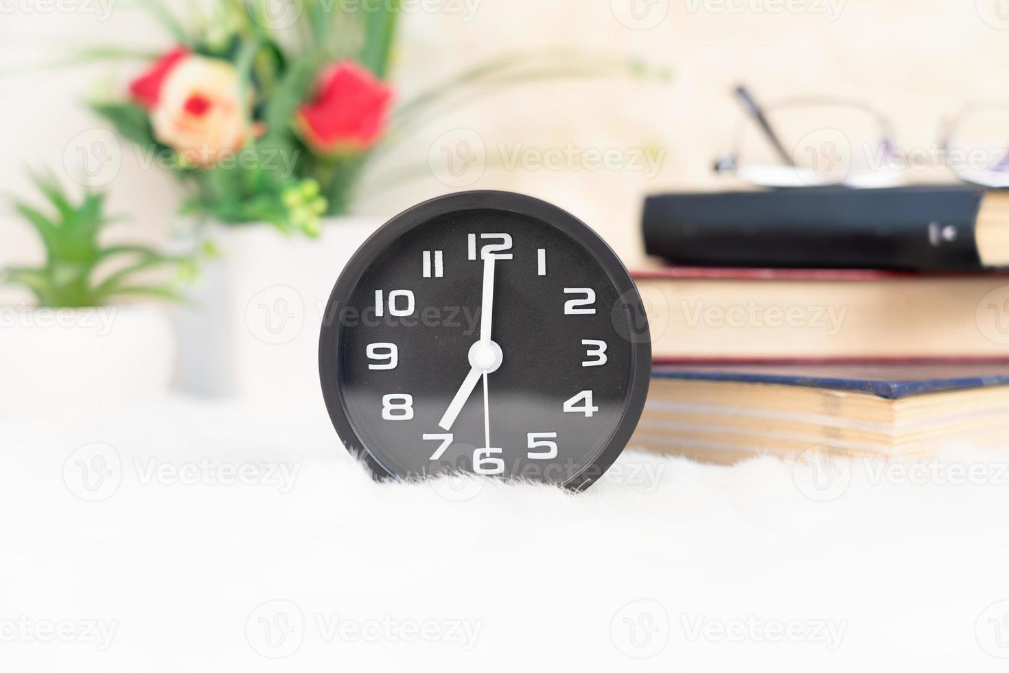 Black alarm clock on table photo