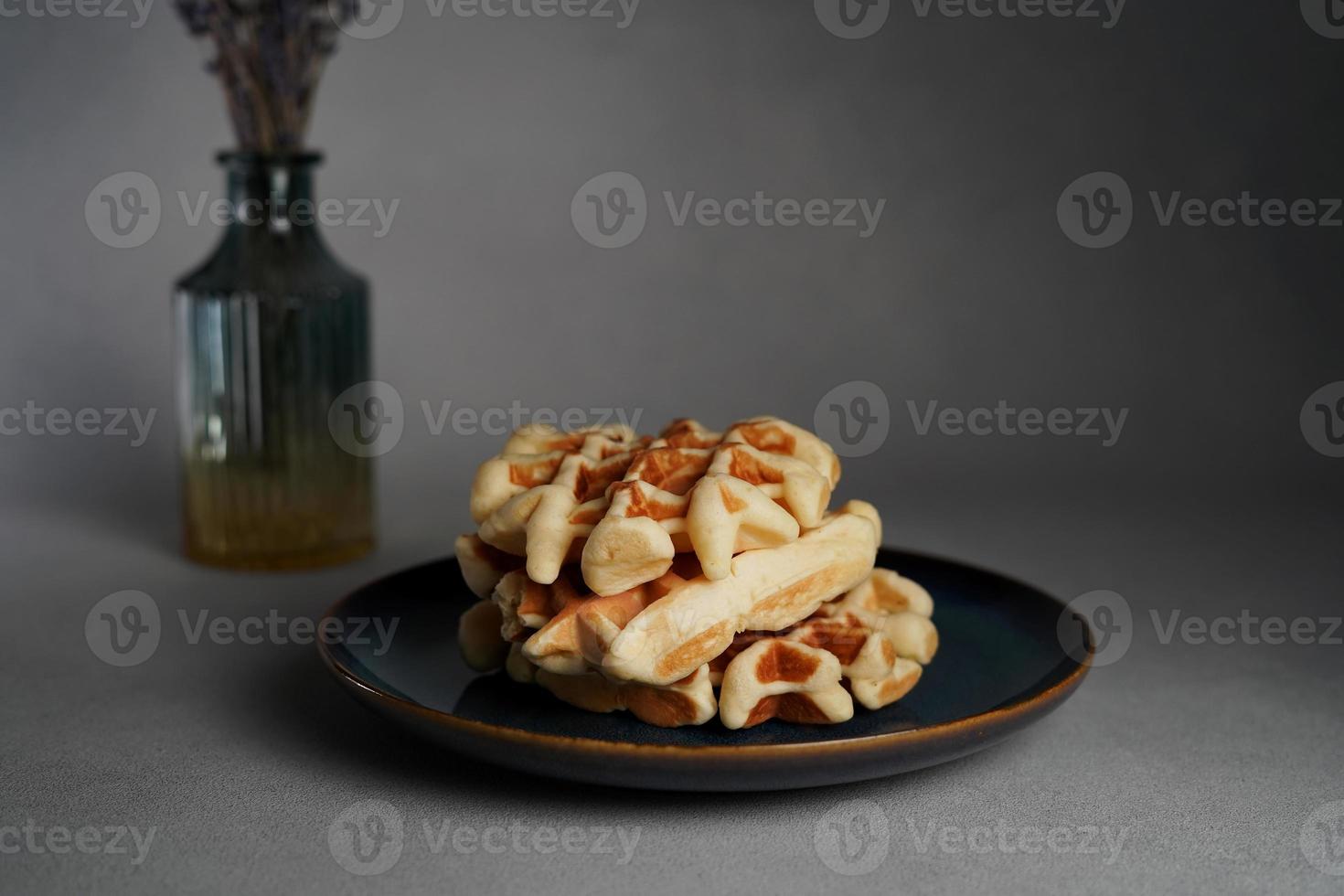 Blue Plate of Homemade Belgian Waffles on Grey concrete Background photo