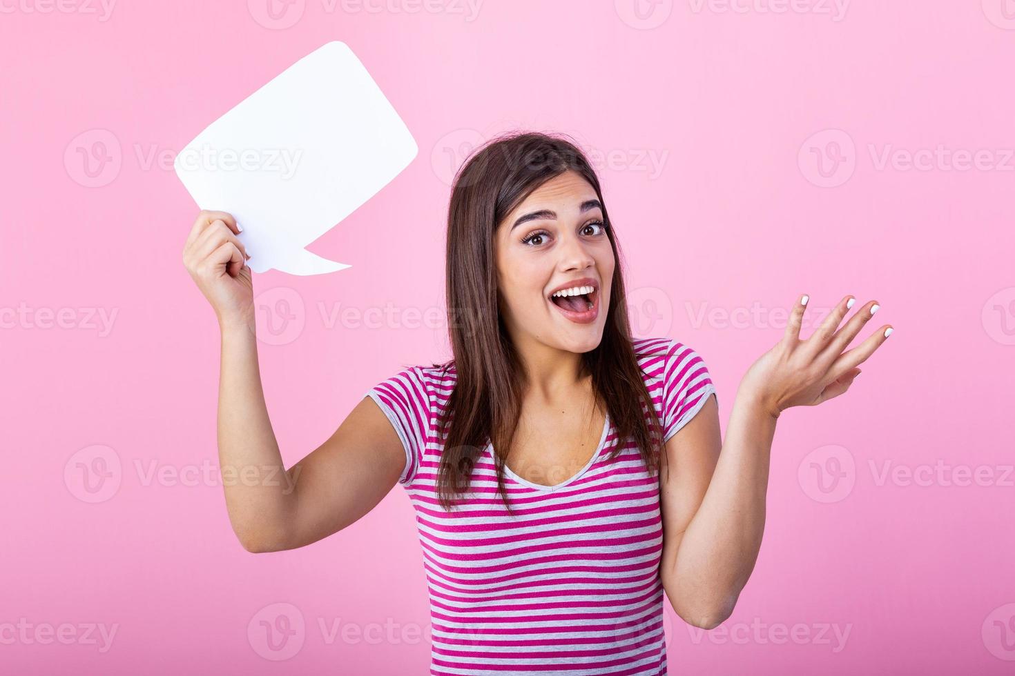 Hey, great idea. Happy pensive beautiful girl looking at blank speech bubble, copy space. Beautiful young joyful model on pink background having idea. photo