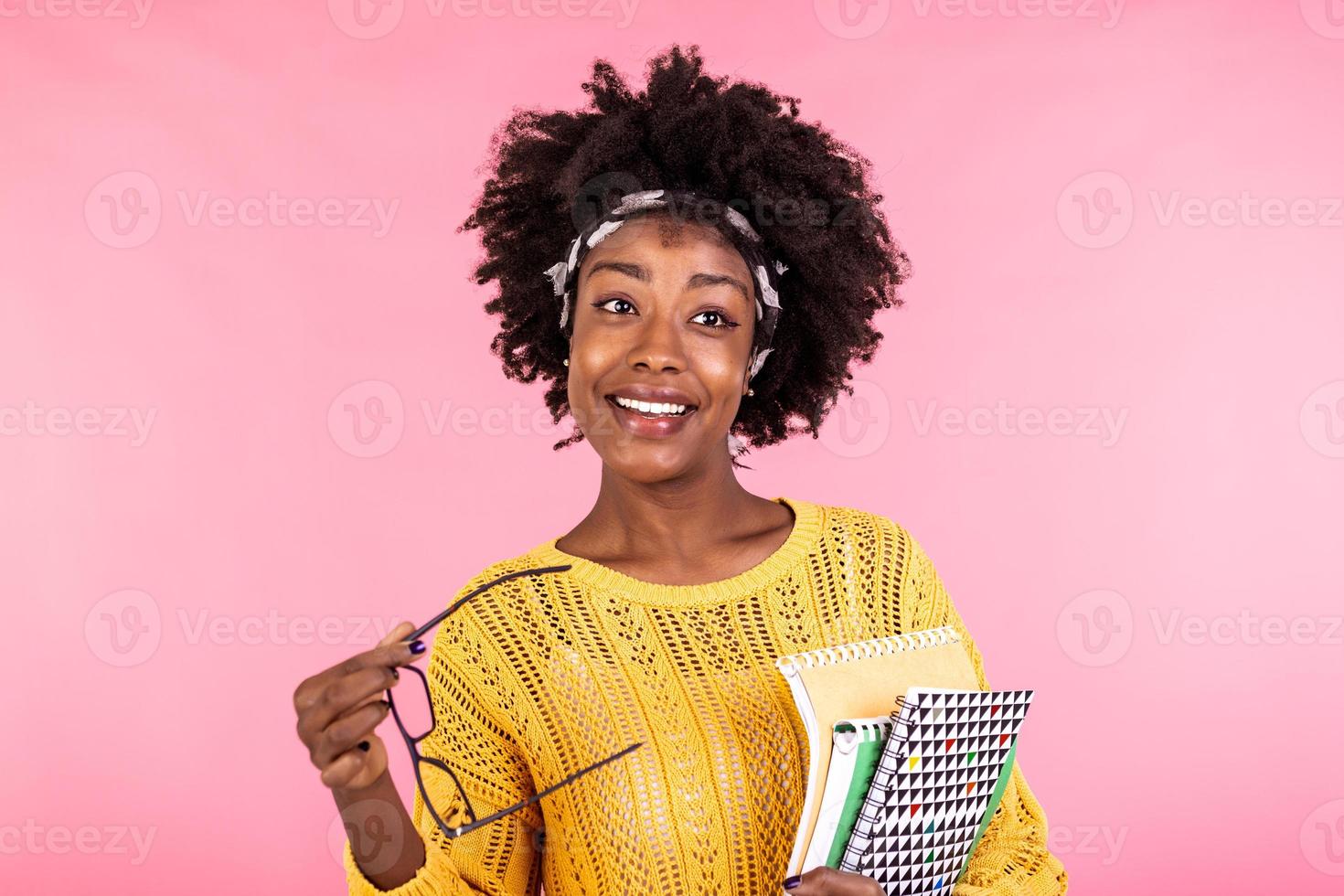 Smiling African American girl student or woman teacher portrait with books in hands. education, high school and people concept - happy smiling young woman teacher in glasses photo