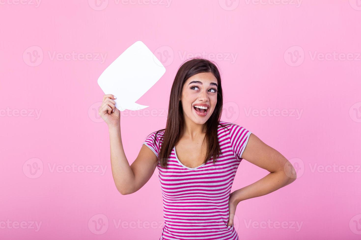 Amazing offer. Overjoyed girl holding empty speech bubble over pink studio background. photo