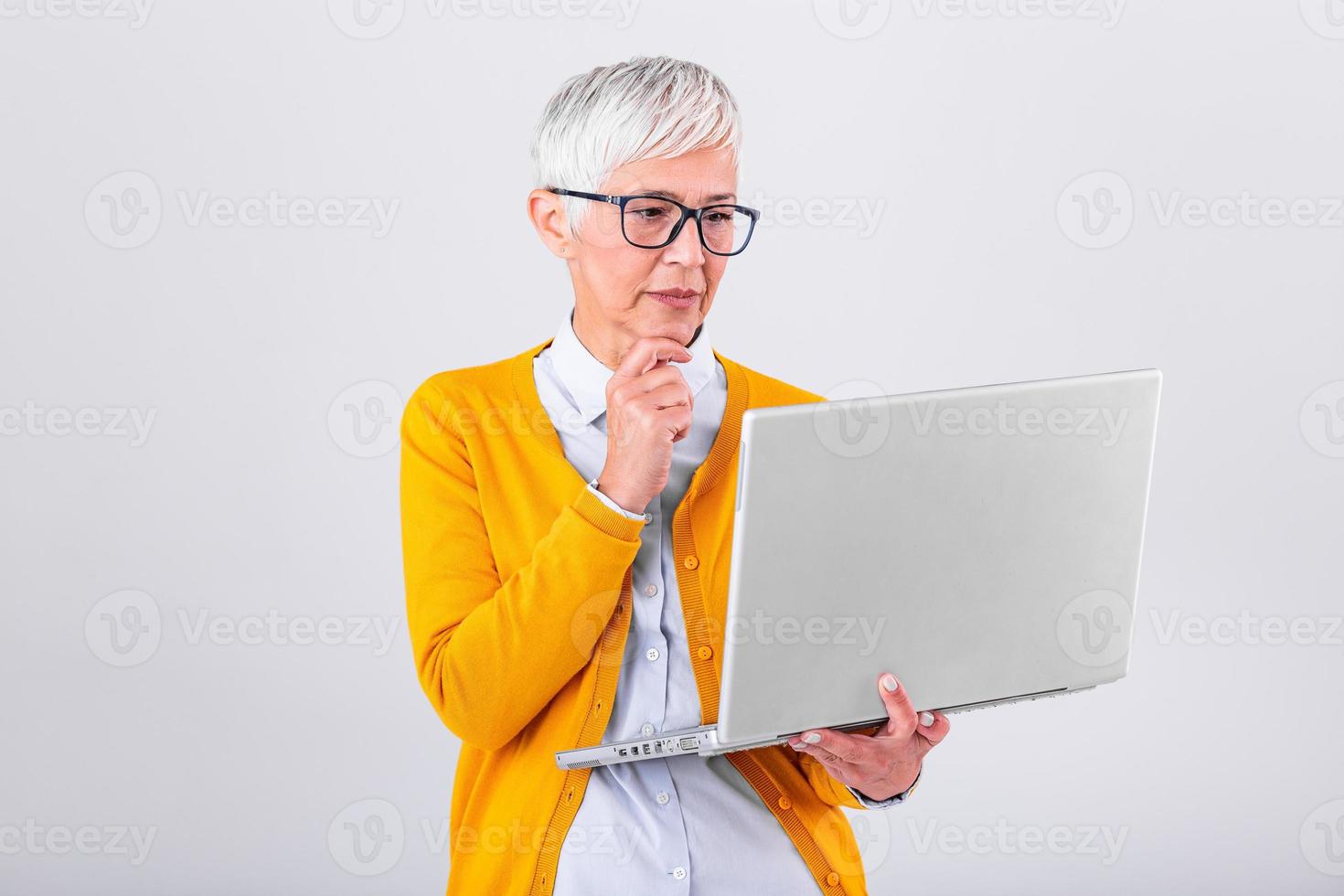 Thoughtful confused mature business woman concerned thinking about online problem looking at laptop, frustrated worried senior middle aged female reading bad email news, suffering from memory loss photo